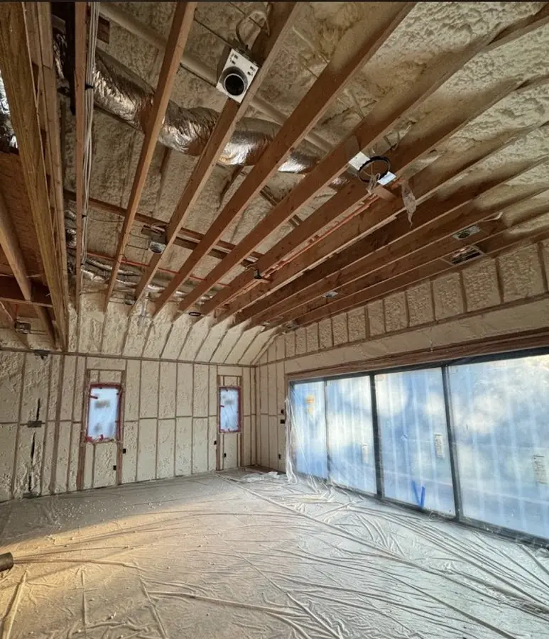 Interior walls and ceiling insulated with spray foam during new construction in Plymouth